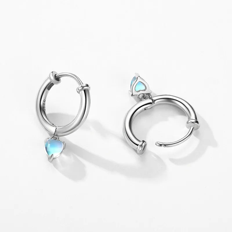 Sterling silver heart hoop earrings with a polished finish and a delicate heart-shaped drop.