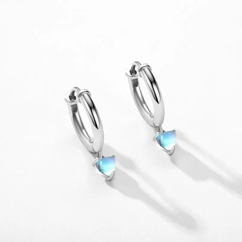 Sterling silver heart hoop earrings with a polished finish and a delicate heart-shaped drop.