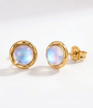 Very small moonstone stud earrings set in 14K gold plated stainless steel with a soft iridescent finish.