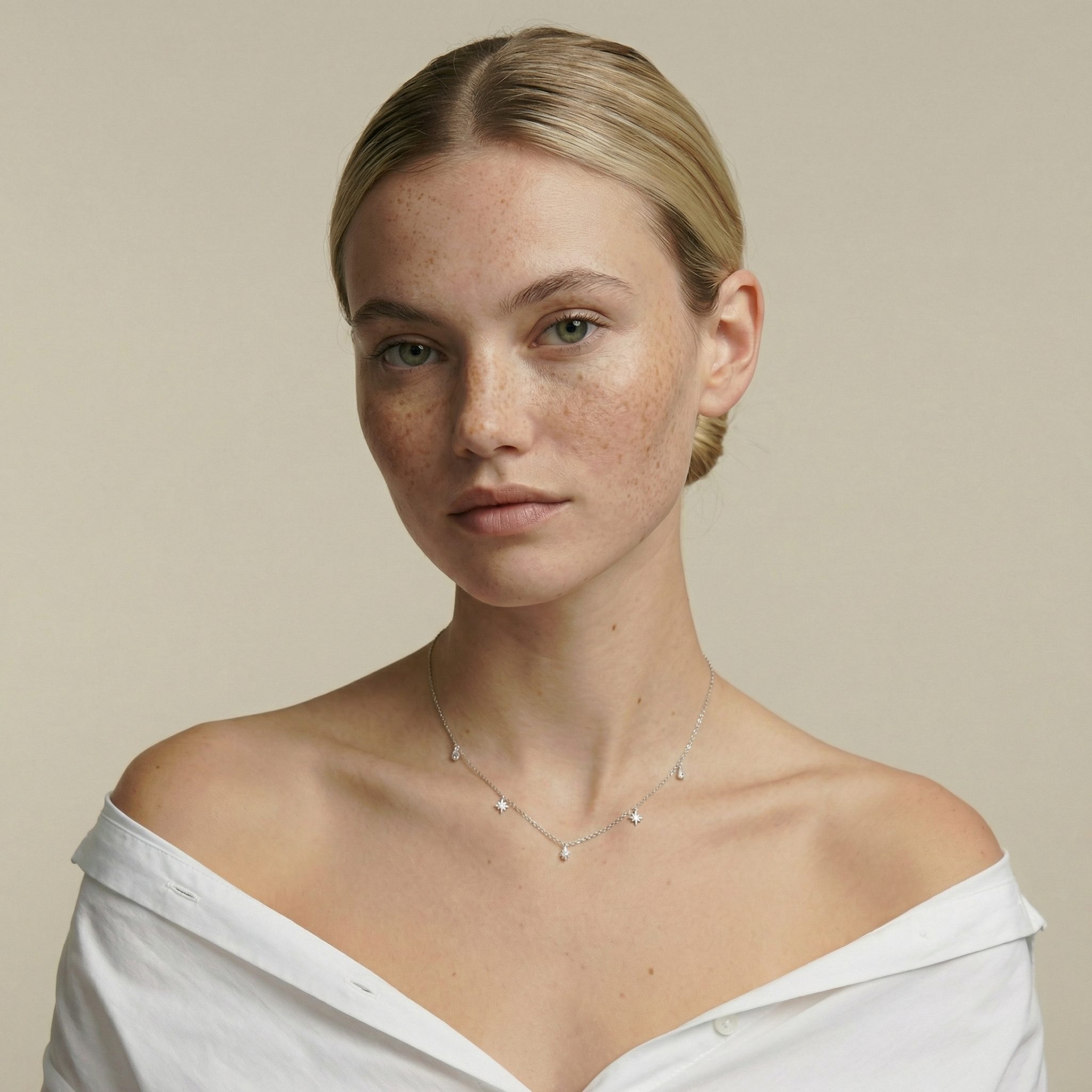 Model wearing a delicate sterling silver zircon necklace with star and water-droplet charms, lightweight women’s jewellery